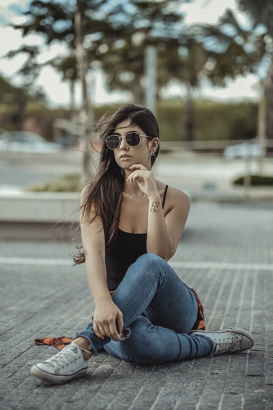 woman wearing shades, black top and blue jeans, clothing, apparel