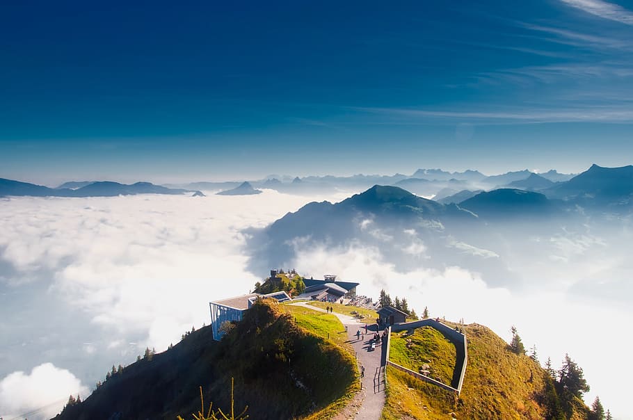 Birds Eye View of House on Hill over White Clouds, alps, daylight