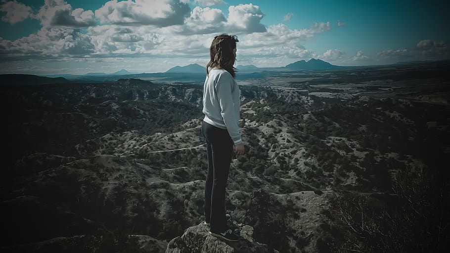 Person in Gray Long-sleeved Shirt Standing on Top of Mountain HD wallpaper