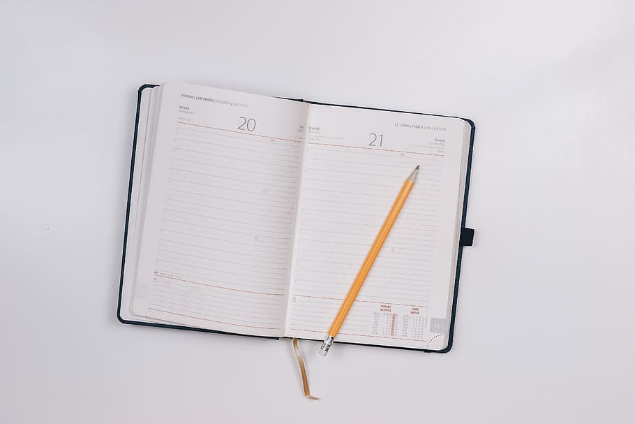 Diary on white table with a pencil, studio shot, education, note pad HD wallpaper