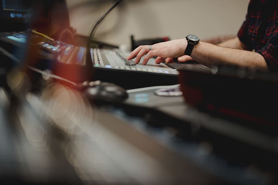 person playing DJ mixer, human, wristwatch, electronics, keyboard