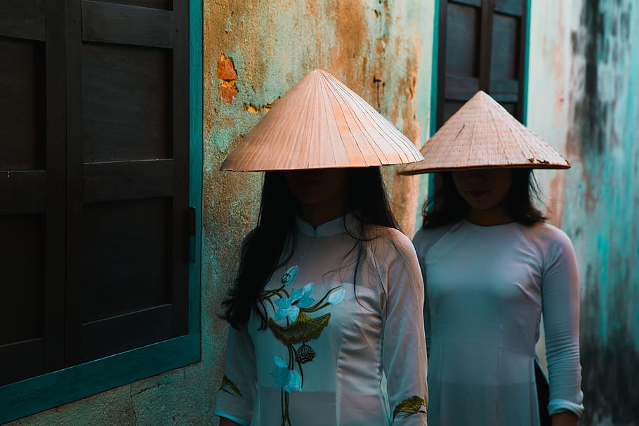two women standing near window, traditional, hat, street, urban