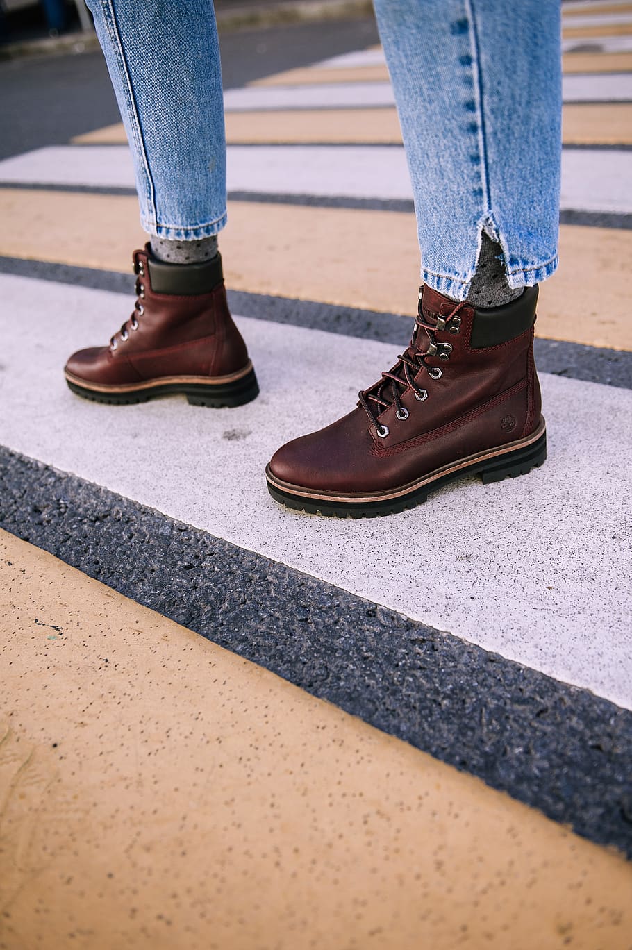 person wearing pair of brown leather boots, footwear, apparel