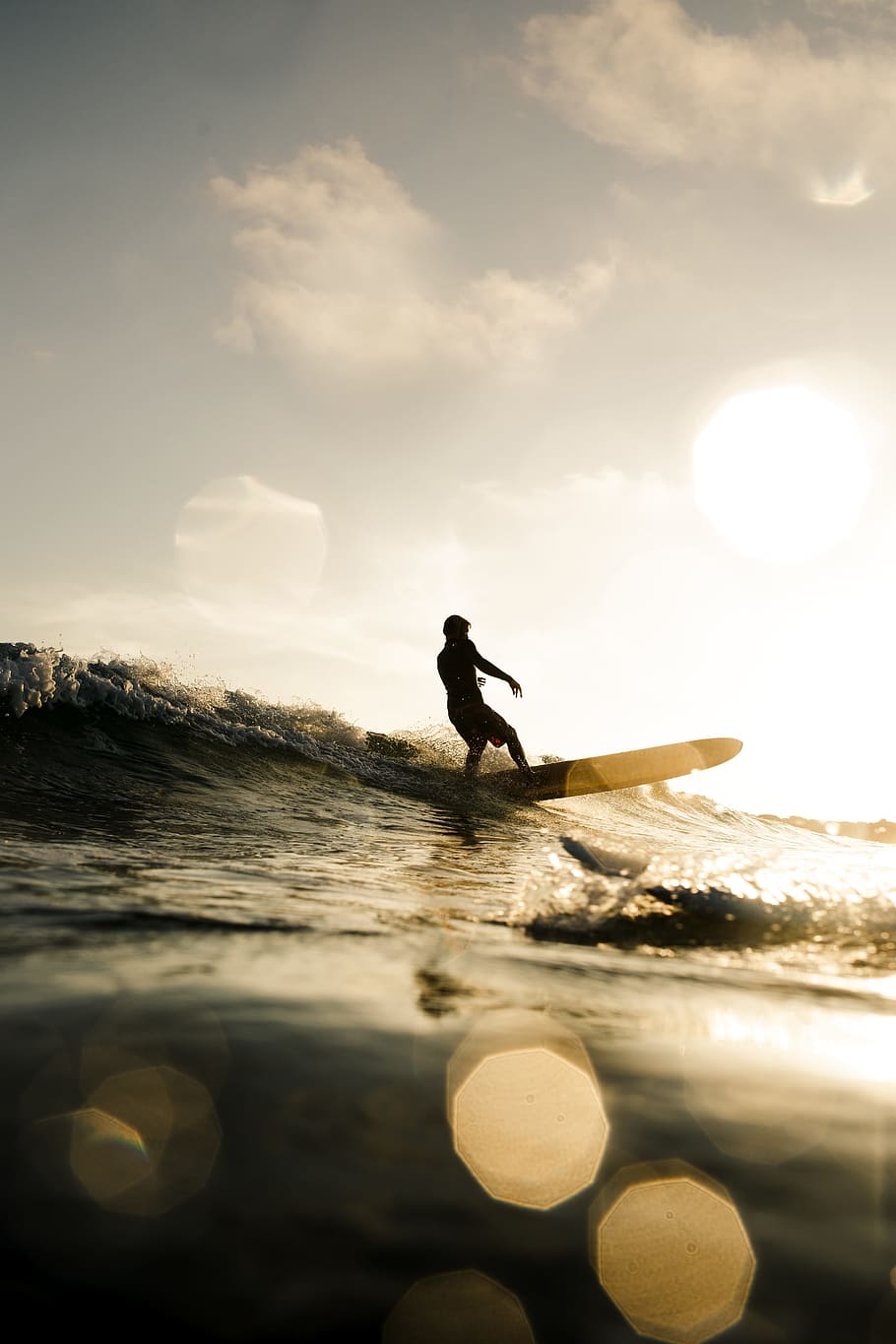 person surfing on wave, surfer, longboard, silhouette, yellow