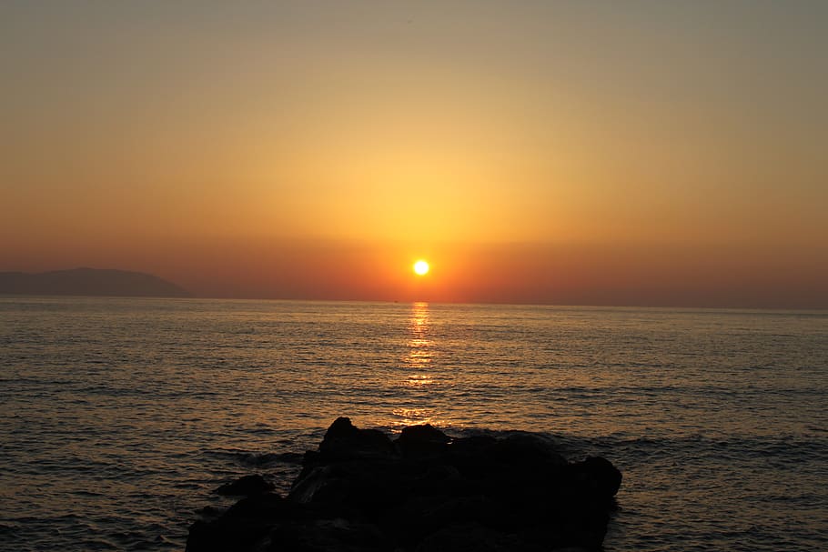 ocean, sundown, light, water, rocks, greece, horizon, sky, sunset HD wallpaper