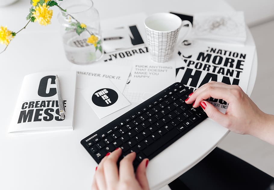 Female hands typing on the remote wireless computer keyboard HD wallpaper