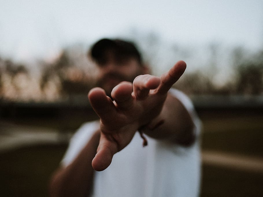 selective focus photography of man pointing his hand, finger