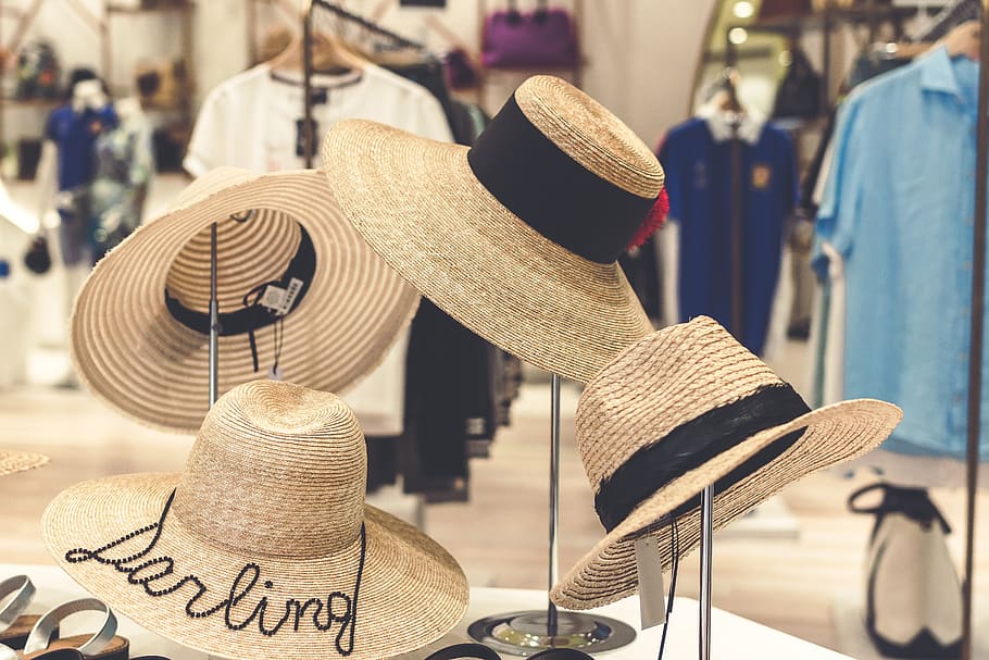 Four Brown Straw Hats Display, accessories, background, boutique