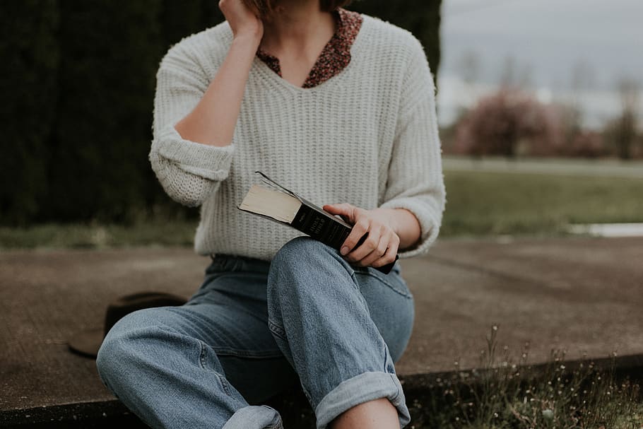 woman sitting while holding book, casual clothing, one person HD wallpaper