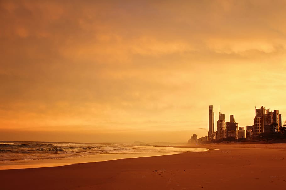 Scenic View Of Ocean During Golden Hour, beach, buildings, clouds HD wallpaper
