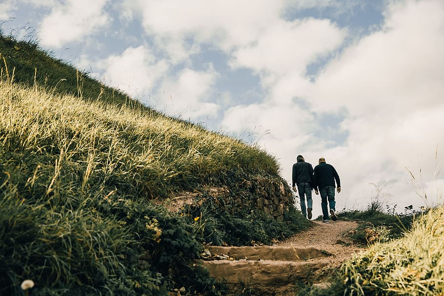 Men hiking on grassy hill s gravel path, adventure, adventurer, HD wallpaper