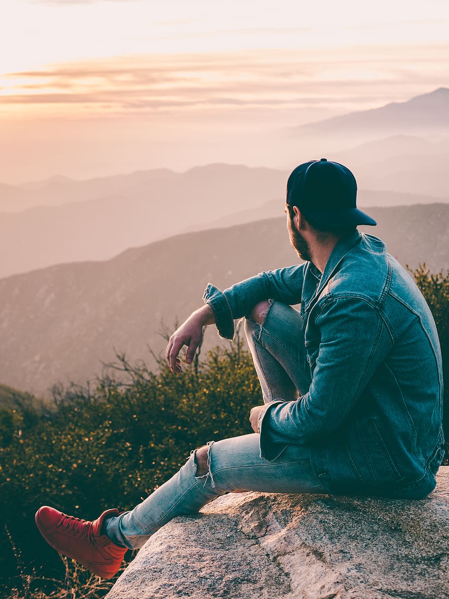man sitting on gray rock, real people, one person, mountain, leisure activity HD wallpaper