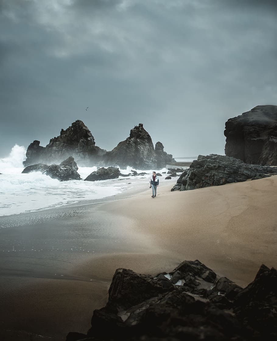 person standing beside rock, shore, coast, wave, water, ocean HD wallpaper