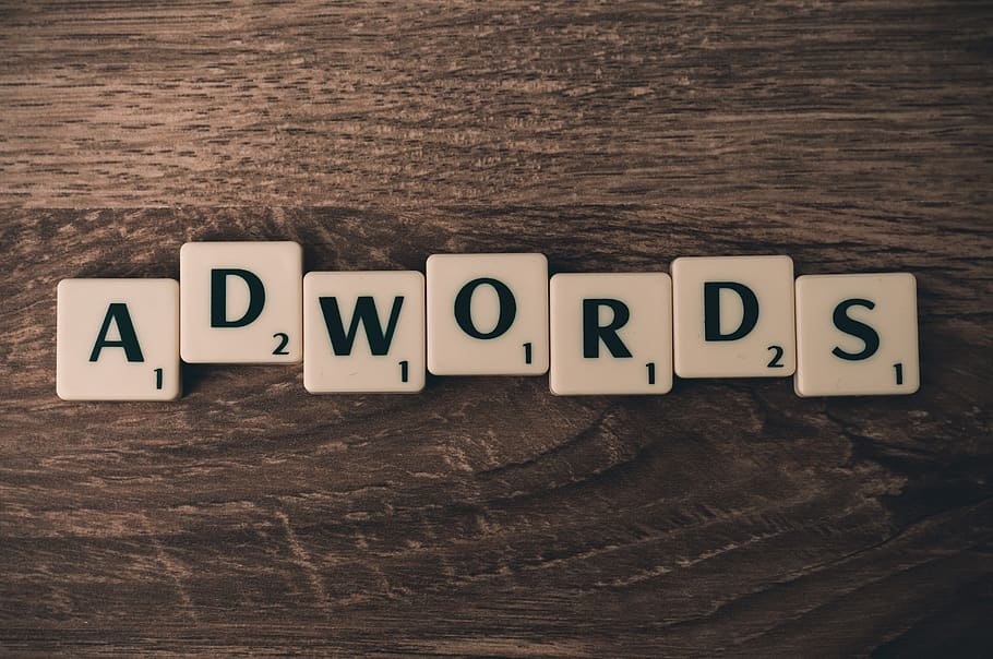 Scrabble Forming Adwords on Brown Wooden Surface, ads, alphabet
