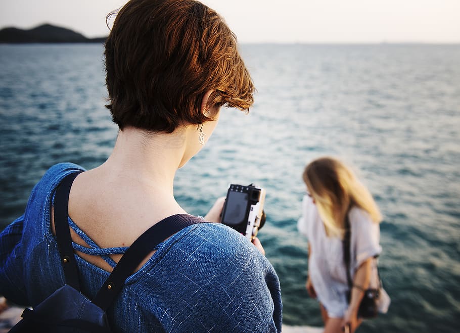 Person Capturing Woman Near Body of Water, back view, blur, camera HD wallpaper