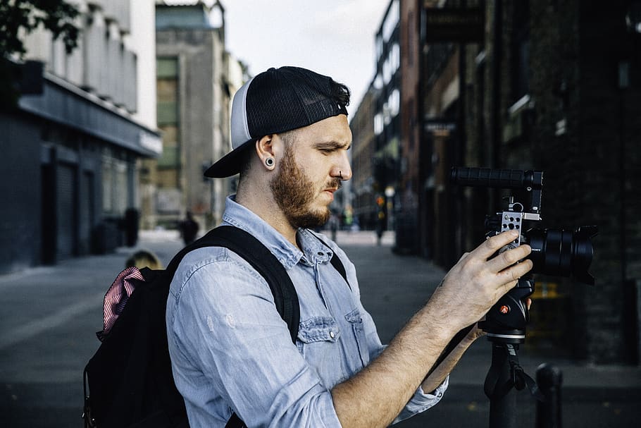 man using black DSLR camera, human, person, apparel, hat, clothing HD wallpaper