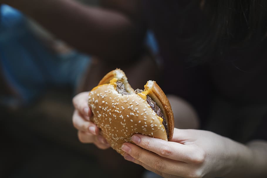 Person Holding Bitten Burger, bite, blur, cheeseburger, daylight HD wallpaper