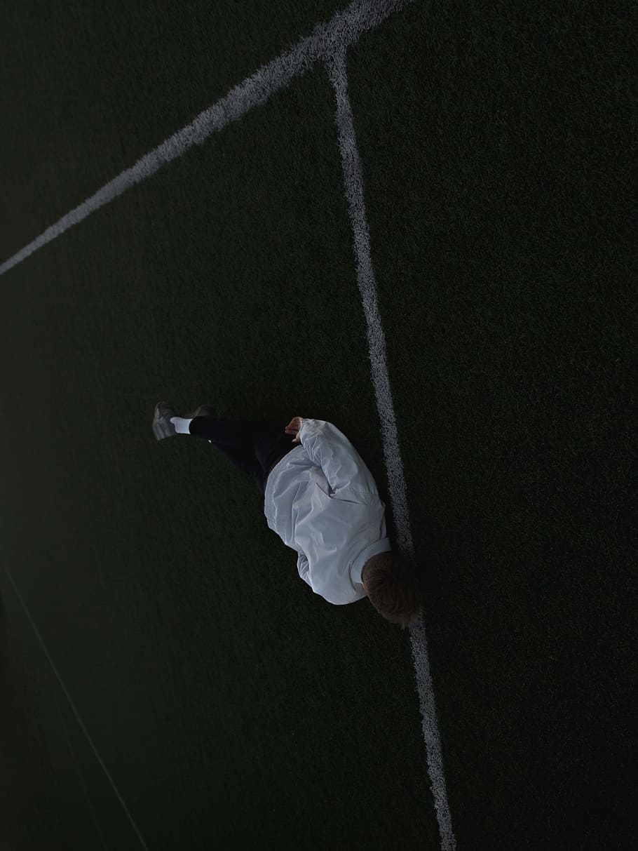 HD wallpaper: man lying on football field, outside, moody, dark, green, guy  | Wallpaper Flare