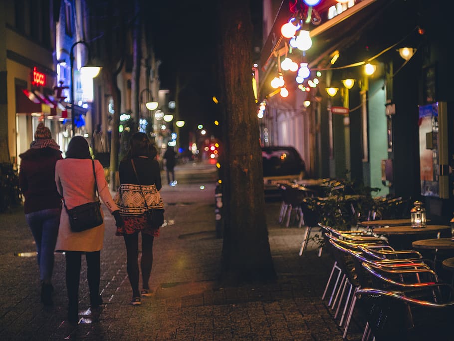 Three Women Walking during Nightime, architecture, bars, buildings