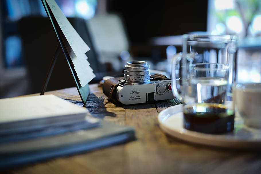 gray camera beside clear glass mug on top of table, vinatge, cup, HD wallpaper