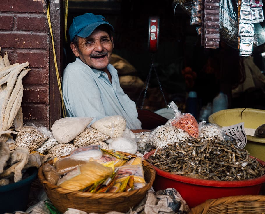 man in blue cap inside store, one person, market, portrait, real people HD wallpaper
