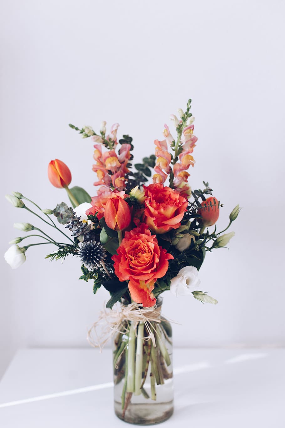 red flower arrangement on white table, spray, pink, blank, green HD wallpaper