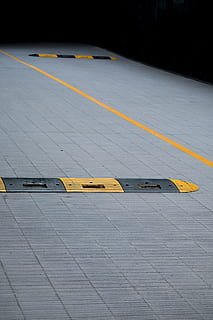 Yellow and Black Plastic Humps on Gray Concrete Floor, alert HD wallpaper