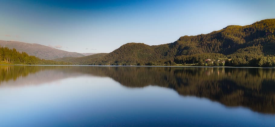 Brown Calm Body of Water Near Mountains Under Blue Sky at Daytime HD wallpaper