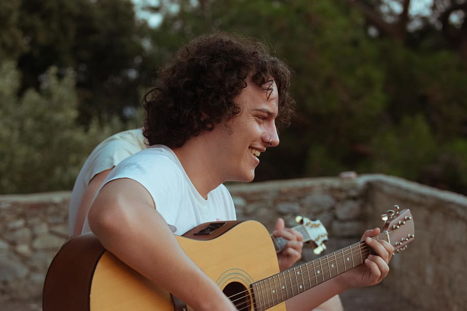 man playing acoustic guitar while smiling, person, human, people HD wallpaper