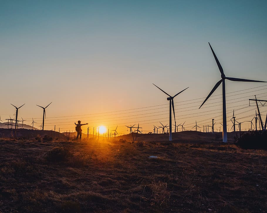 silhouette photography of person standing near windmill, sunset HD wallpaper
