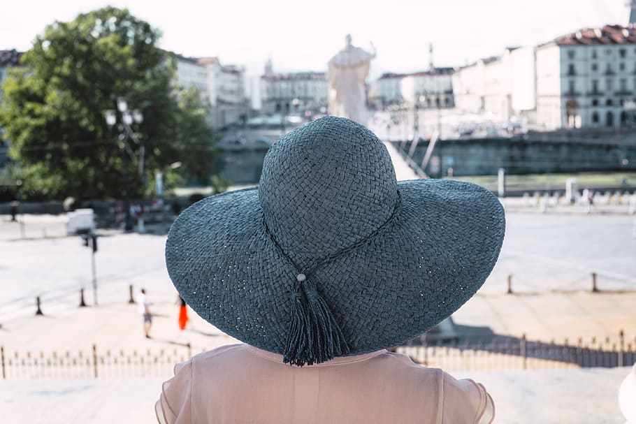 Girl in blue hat on Piazza Gran Madre di Dio in Turin Italy, antonelliana