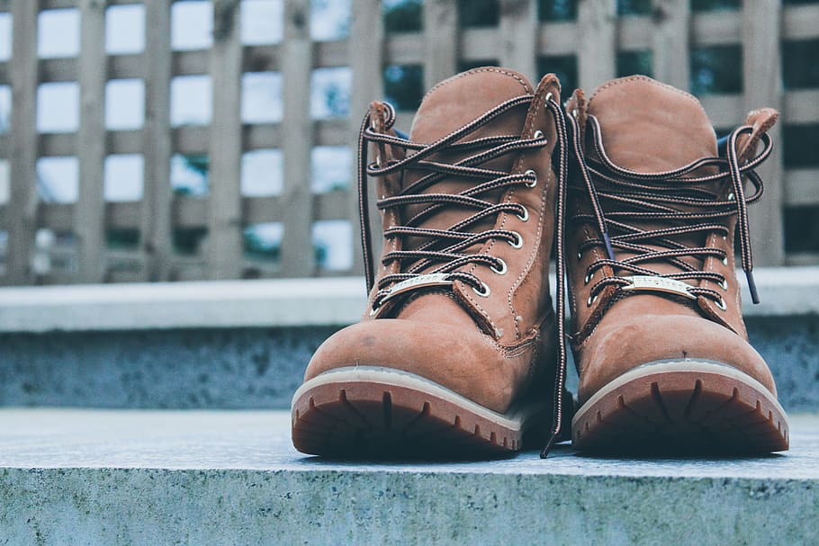 pair of brown leather boots on gray concrete pavement, apparel, HD wallpaper