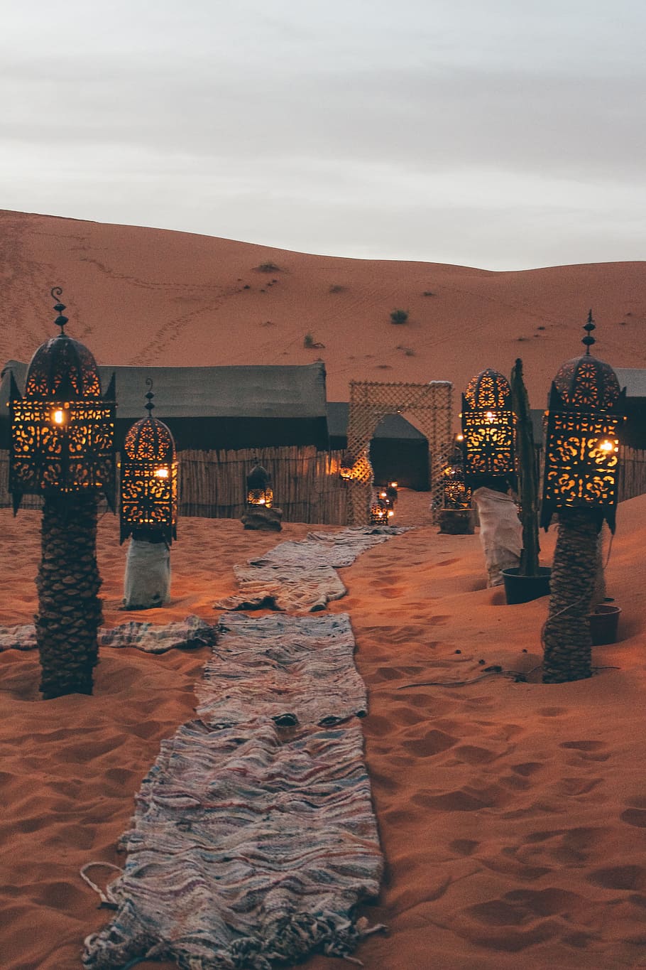 four black metal lamps beside grey pathway, light, north africa