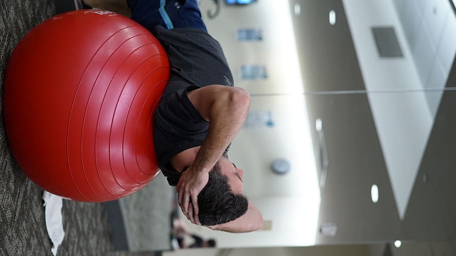 man lying on red stability ball, one person, real people, men HD wallpaper