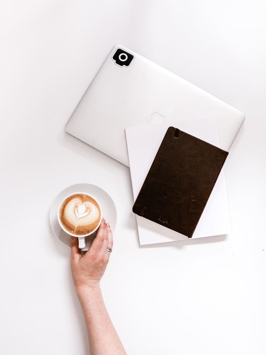 cappuccino beside closed MacBook, cup, coffee cup, text, drink HD wallpaper