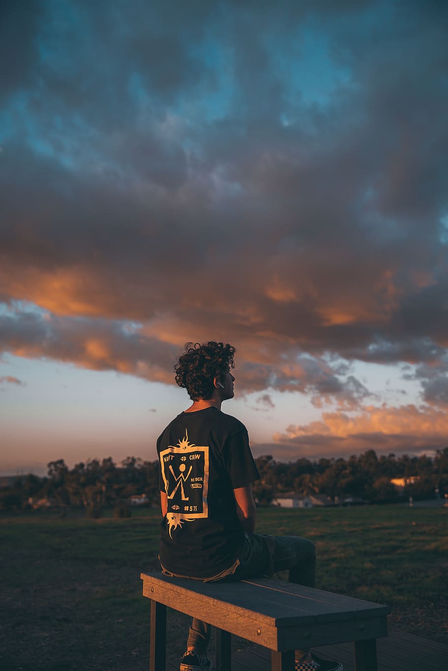 man sits on bench under dark sky, apparel, clothing, person, human HD wallpaper