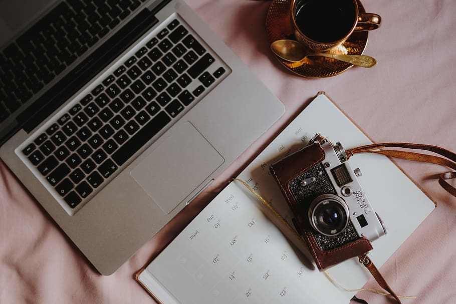 Workplace with a laptop on a pink couch, macbook, macbook pro HD wallpaper