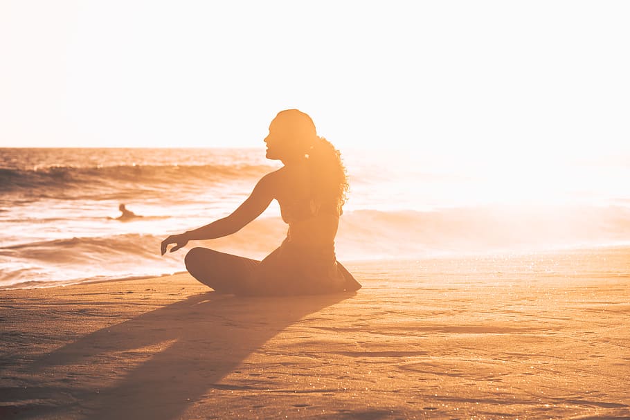 silhouette of woman sitting by the seashore during sunset, ocean HD wallpaper