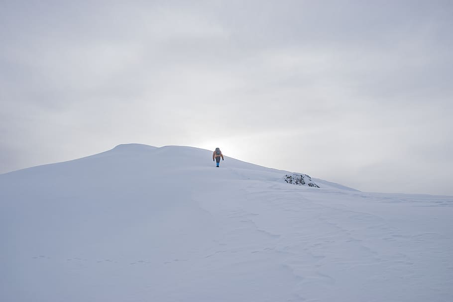 man walking through peak, nature, mountain, outdoors, slope, mountain range HD wallpaper