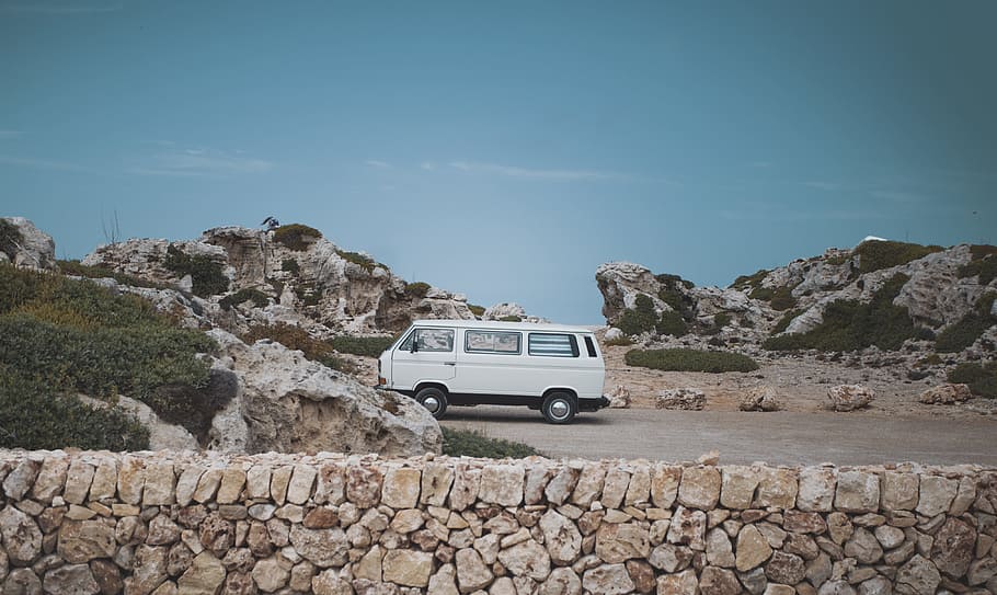parked white conversion van, wall, stonework, sky, rock, car
