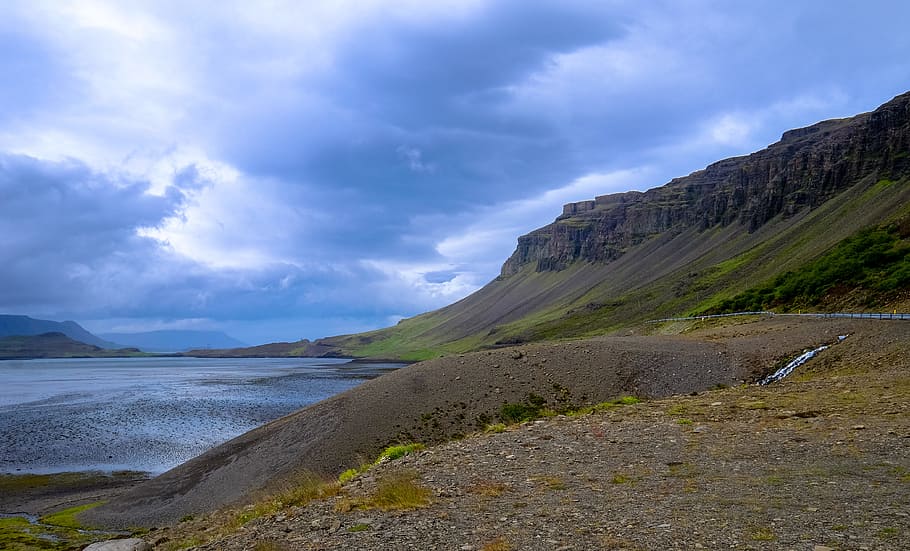Mountains Near Water Under Cloudy Day Sky, cliff, daylight, grass HD wallpaper