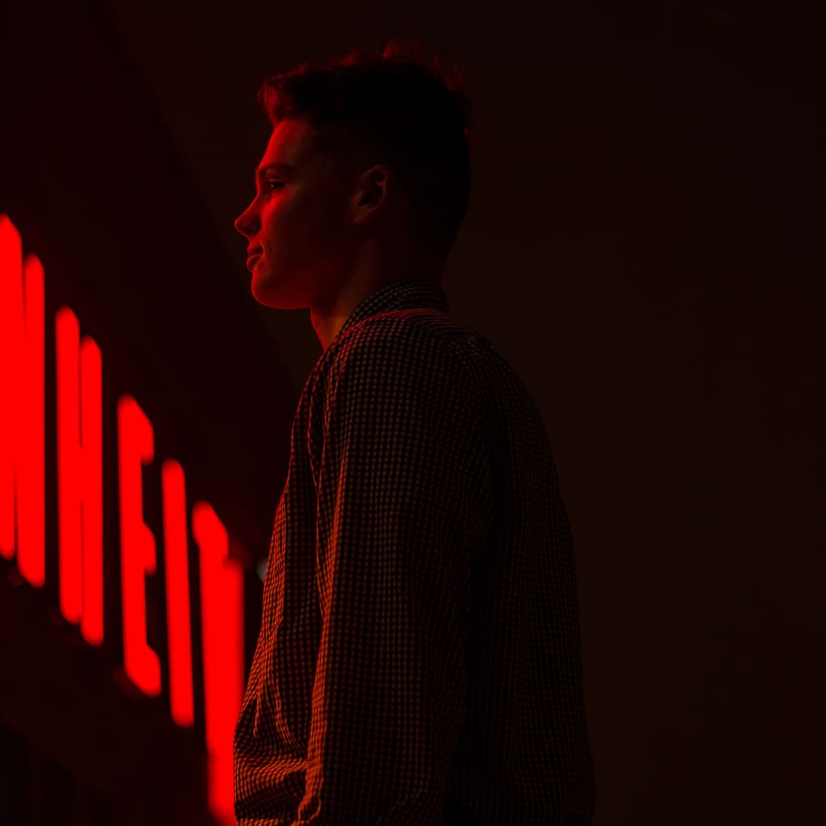 one-unknown-celebrity-in-black-long-sleeved-shirt-standing-front-of-neon-light-signage.jpg