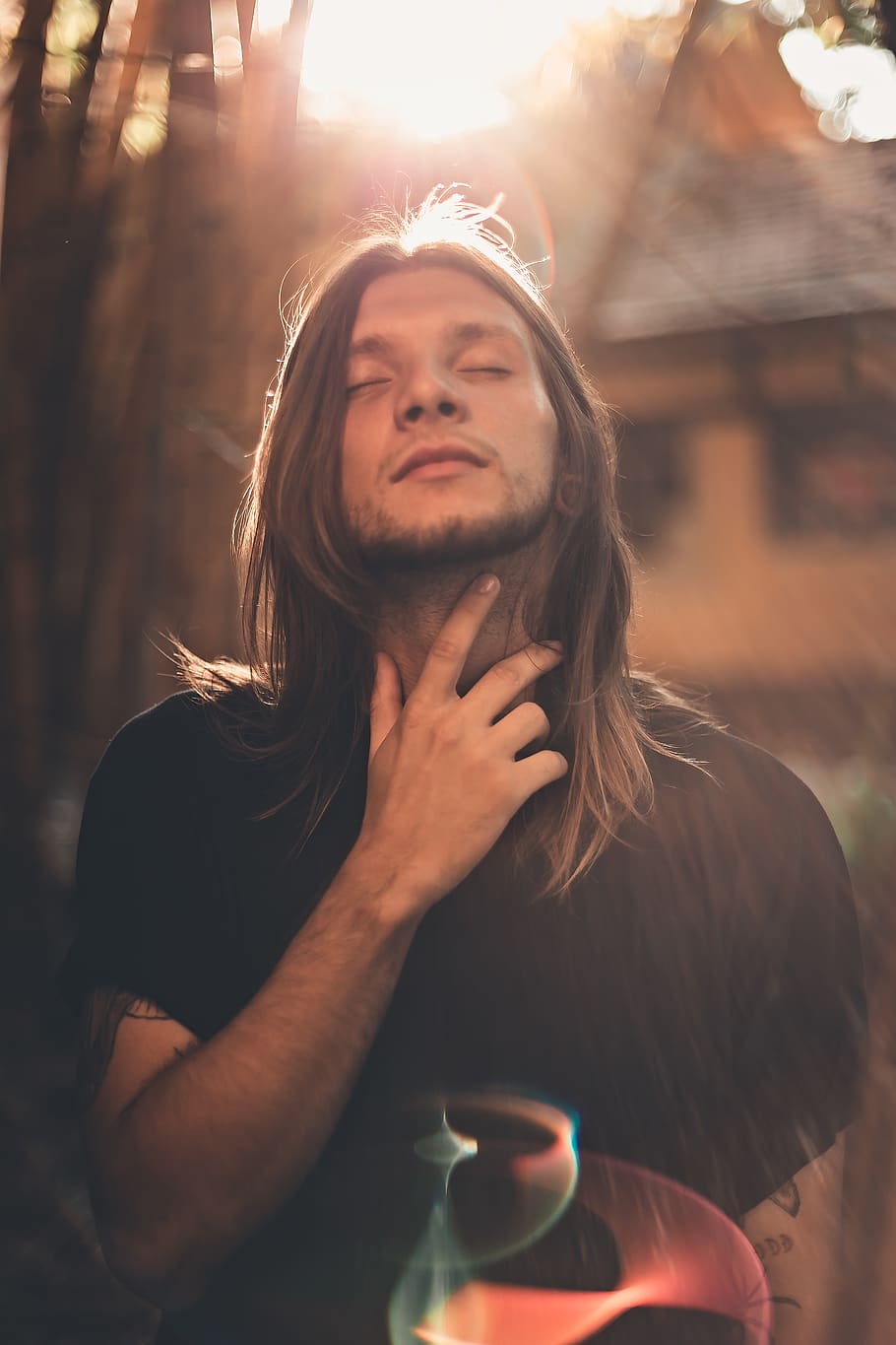 man with long hair, blond hair, blurred background, casual, close-up