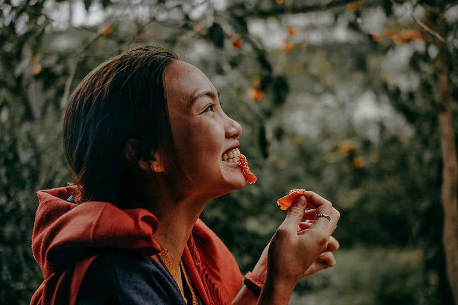 Woman Biting Red Fruit, blurred background, close-up, eating HD wallpaper