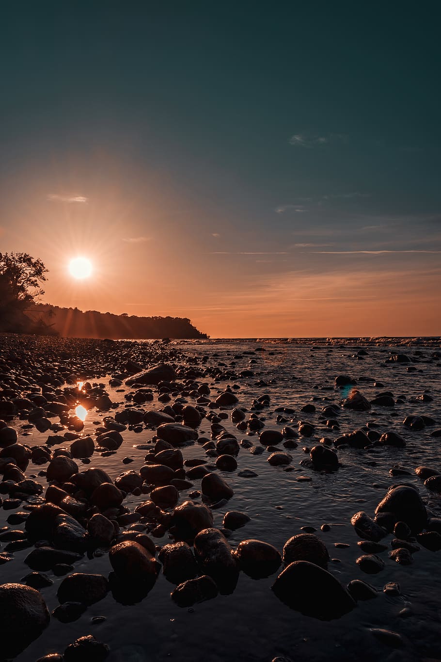 Photo Of Rock Rubles Beside Calm Body Of Water during Golden Hour HD wallpaper
