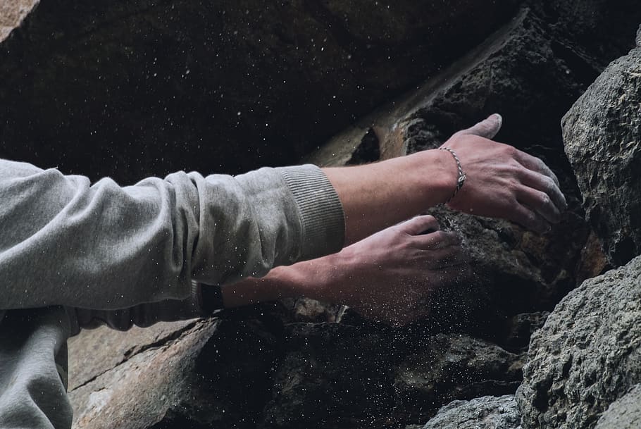 person touching rock, new zealand, purakaunui, long beach sea cave HD wallpaper