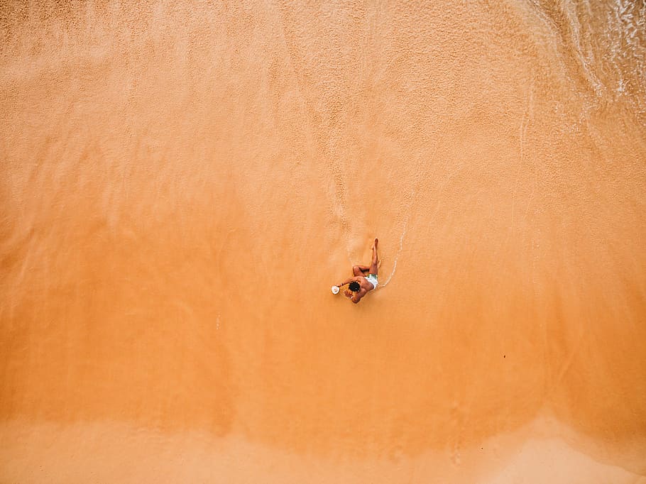 man sitting on seashore, sand, land, nature, high angle view HD wallpaper