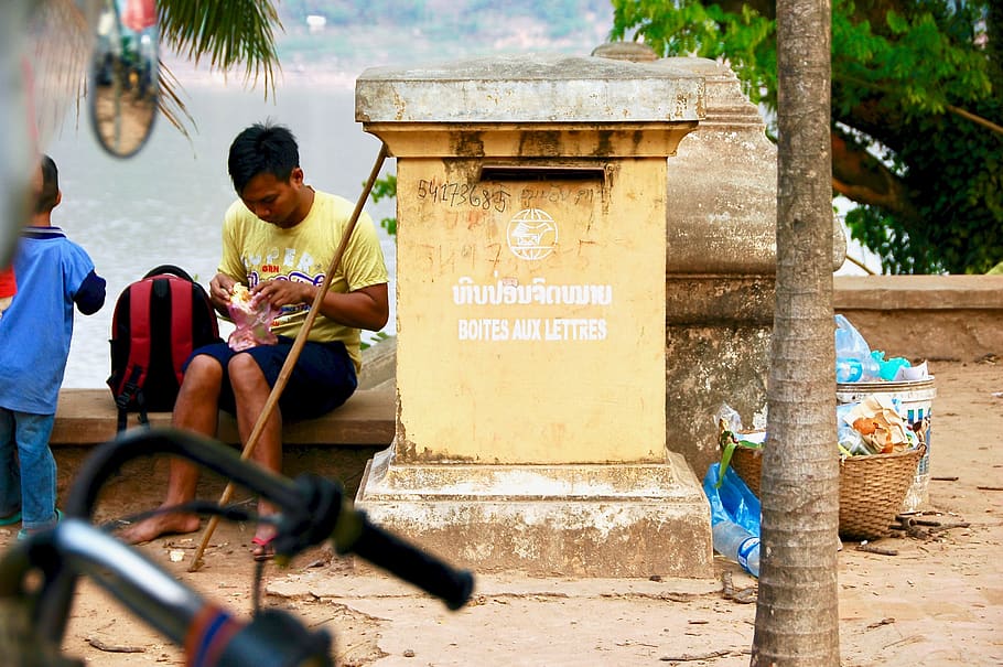 man sitting beside concrete mailbox, person, human, people, flora HD wallpaper