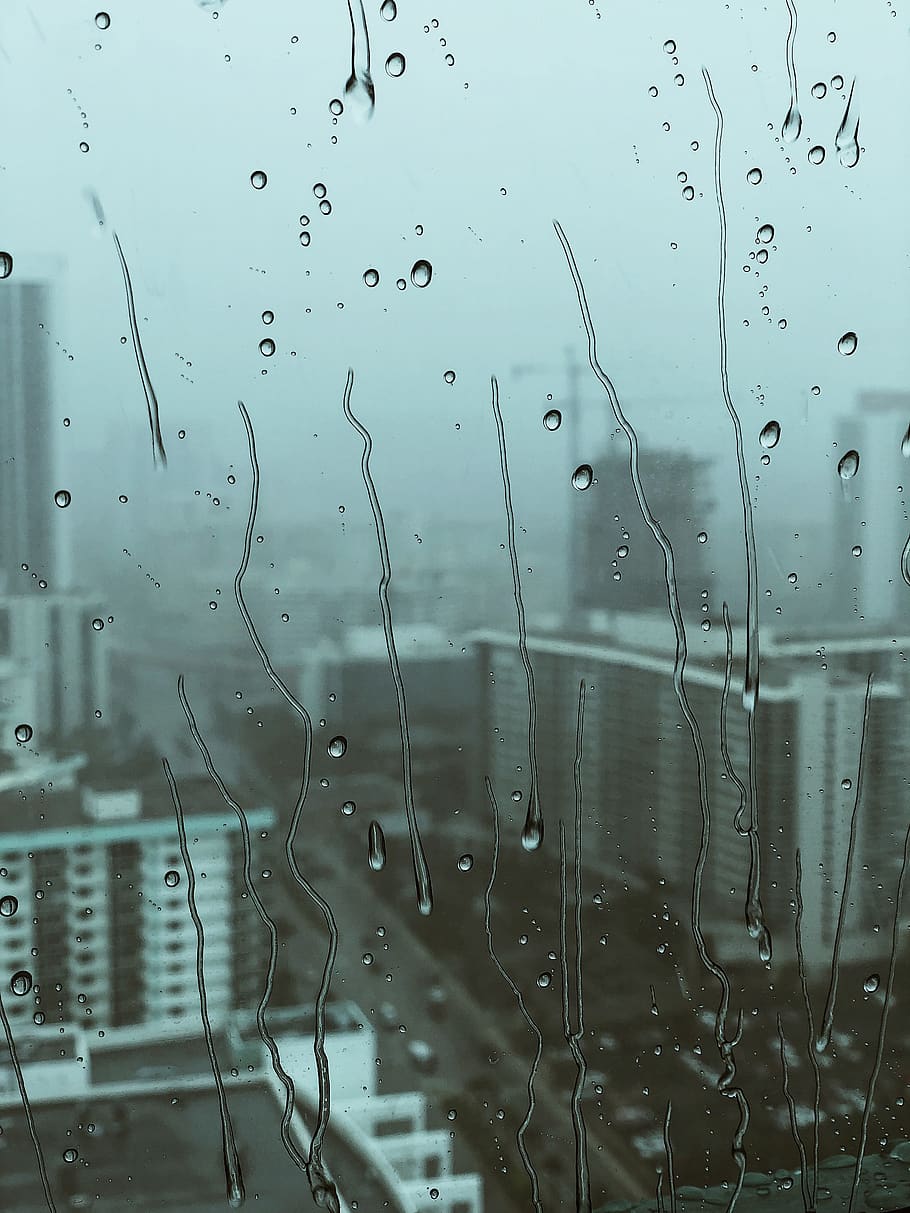 HD wallpaper: view of cityscape from glass with water droplets ...