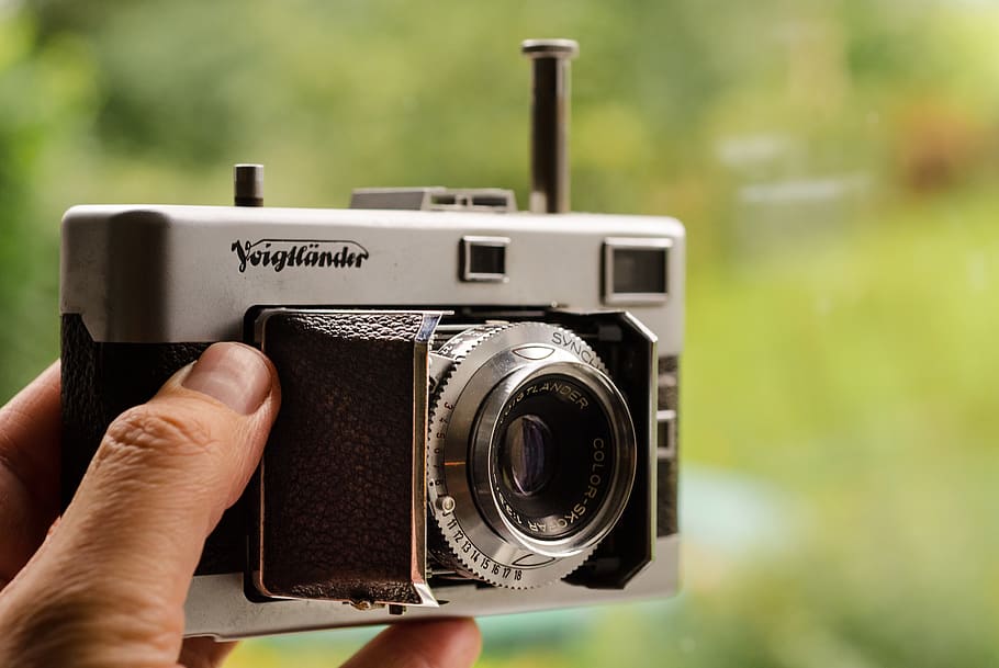 Close-up Photography of Person Holding Gray and Black Film Camera HD wallpaper